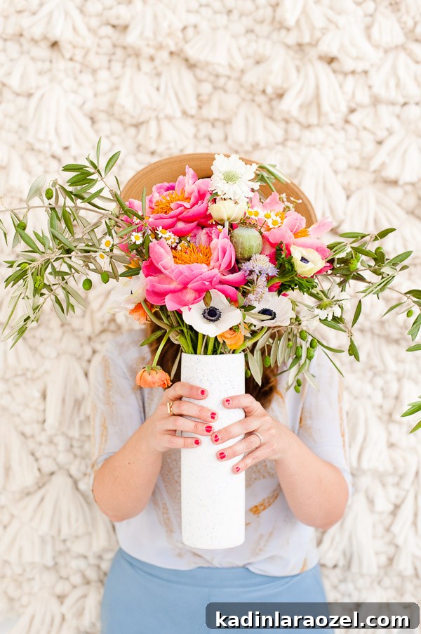 Loving this DIY bouquet of peonies, anemones, and olive branches.