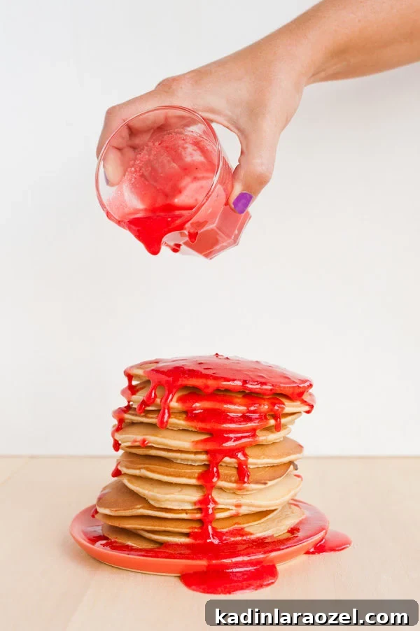 Peanut Butter and Jelly Pancakes That Will Surprise Your Tastebuds 3 Peanut butter pancakes with strawberry 'jelly' syrup