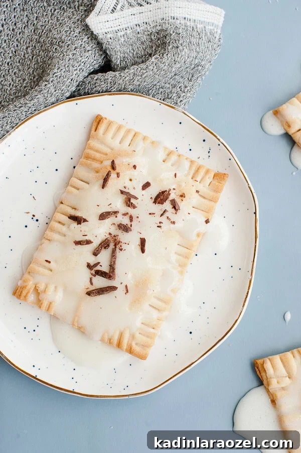 Chocolate + caramel bourbon filled pop tarts with a marshmallow glaze. #recipe