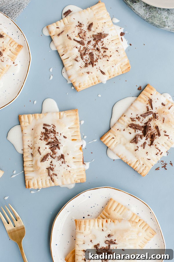 Drunken S'more Pop Tarts. Try this semi-homemade recipe for pop tarts with chocolate + caramel bourbon filling and a marshmallow glaze.