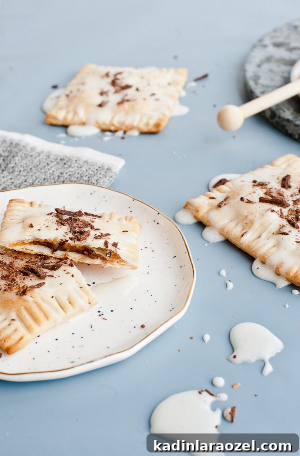 Drunken S'more Pop Tarts. Try this semi-homemade recipe for pop tarts with chocolate + caramel bourbon filling and a marshmallow glaze.