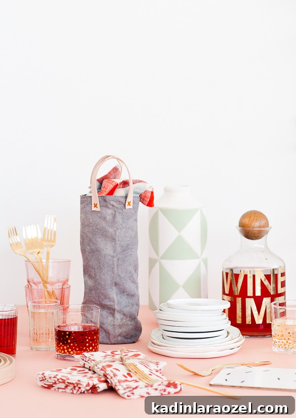 Festive DIY Canvas Wine Bags for Holiday Hostess Gifts 9 Wine bag with leather handles, sitting on a table with other bar cart items.