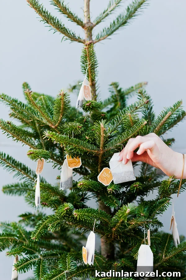 Decorate a mini Christmas tree with tea bags for guest to grab and go for keeping warm at an outdoor winter party