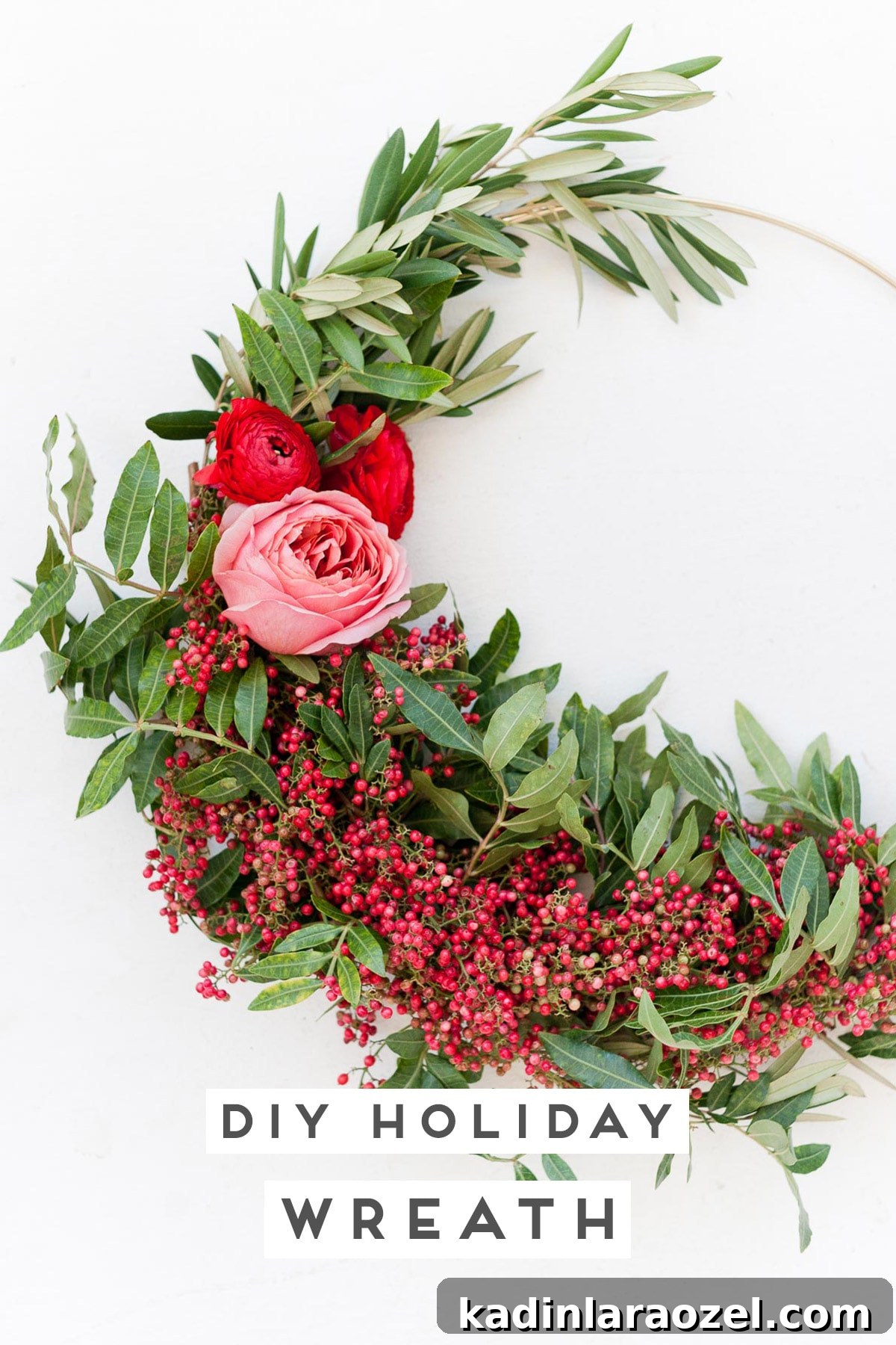 Create an Asymmetrical Wreath: Step-by-Step Design Guide 9 Closeup of holiday wreath with red berries and pink flowers in asymmetrical design