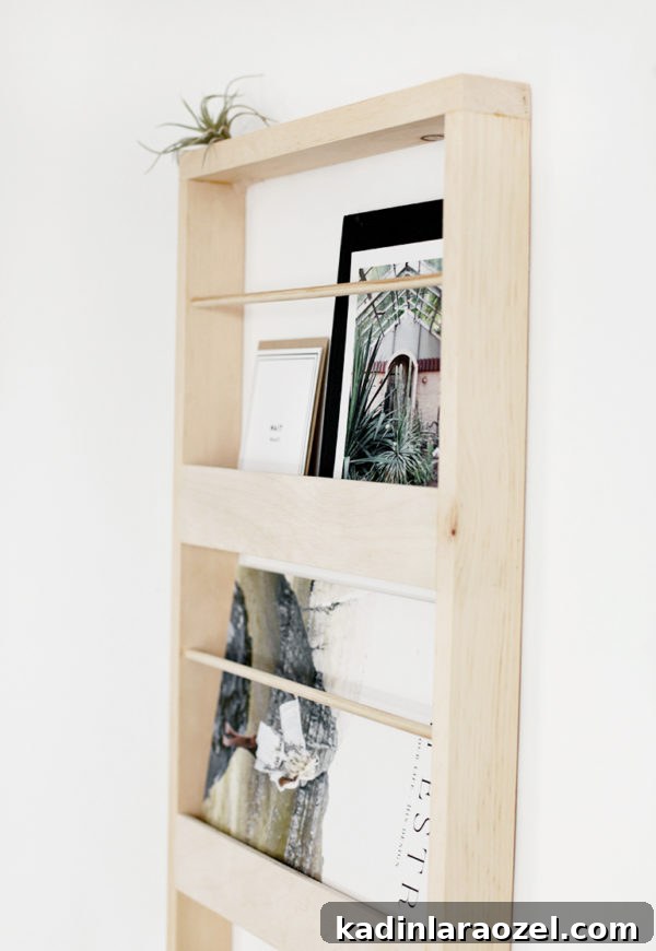 49 Clever DIY Home Organization Ideas to Maximize Space 29 A wood magazine holder that hangs on the wall.