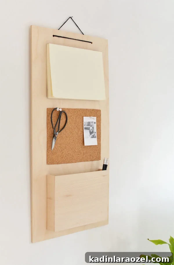 49 Clever DIY Home Organization Ideas to Maximize Space 34 A hanging wall organizer made of wood and cork, with scissors hanging from it.