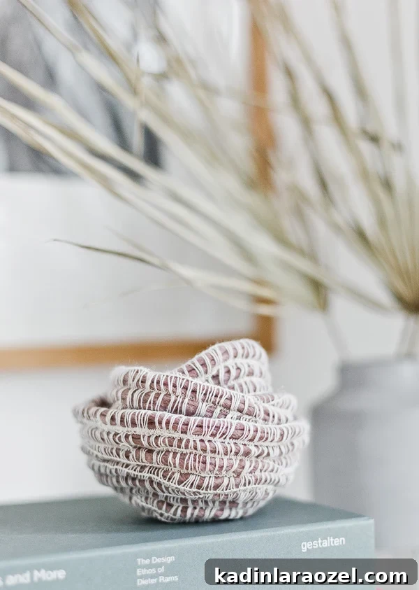 49 Clever DIY Home Organization Ideas to Maximize Space 50 Simple yarn baskets in a mauve color, resting on a grayish blue book.
