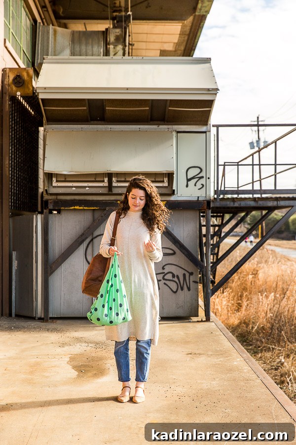 DIY Reusable Grocery Bags from Old T-Shirts in 10 Minutes 3 A woman holding a neon green polka dot grocery bag.