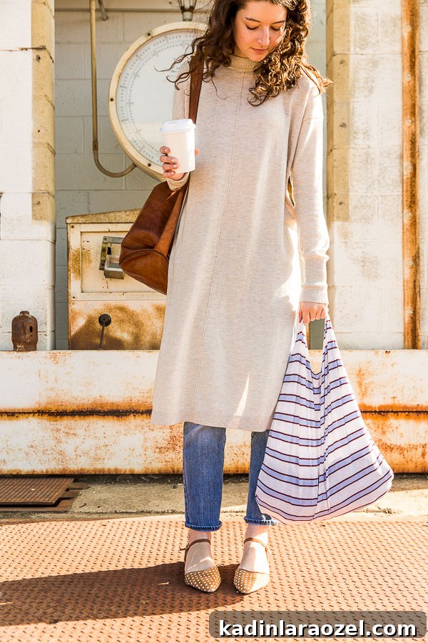 DIY Reusable Grocery Bags from Old T-Shirts in 10 Minutes 10 Woman holding a coffee and a striped grocery bag.