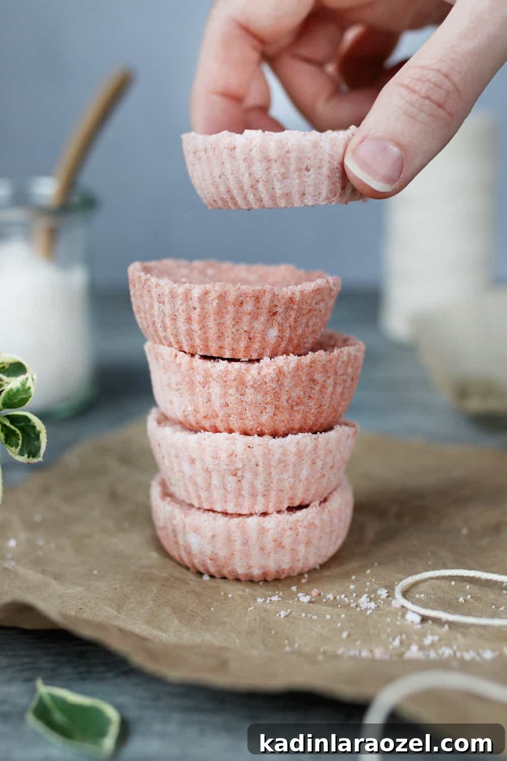 49 Creative DIY Valentine Gift Ideas for Loved Ones 23 woman's hand stacking flat, pink bath bombs on top of each other
