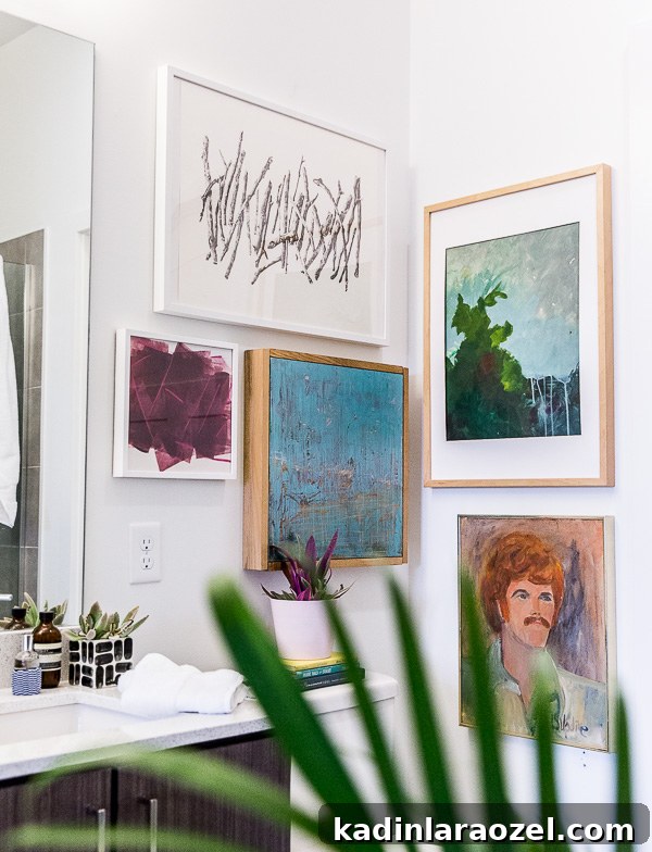Before and After: My New Master Bathroom Remodel Reveal 7 Add a gallery wall in a small bathroom to add depth and character. Click through for more tips and a before and after minimal modern bathroom makeover.