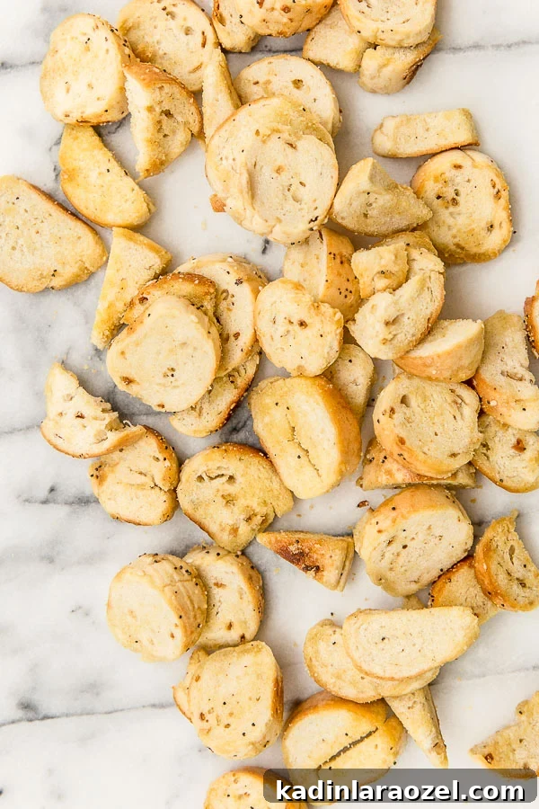 everything bagel chip slices spread out on a marble cutting board