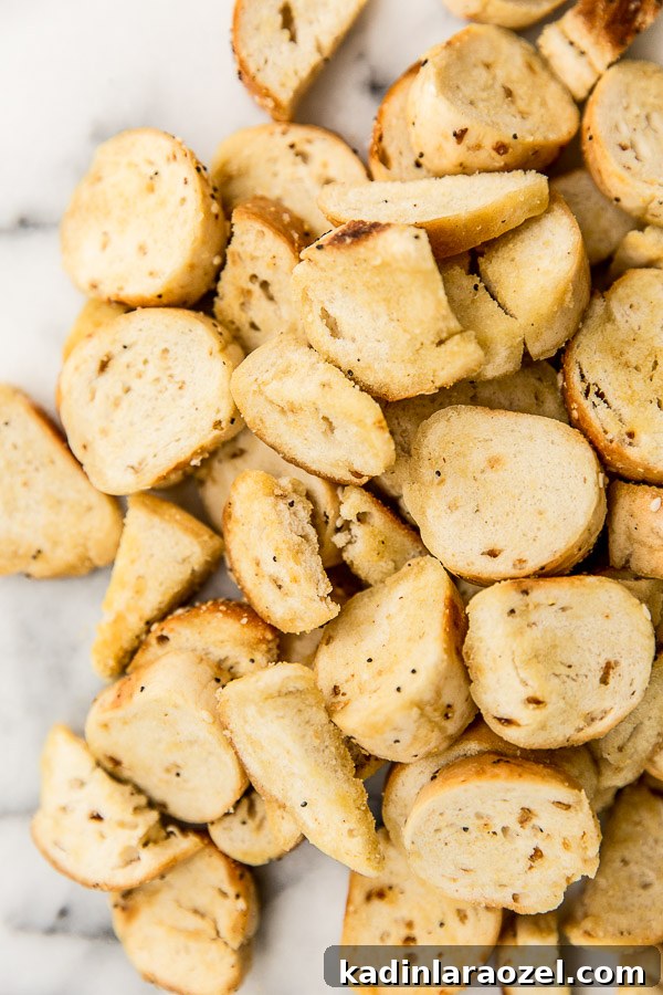 closeup of homemade bagel chips after they've been baked and cooled on a marble counter