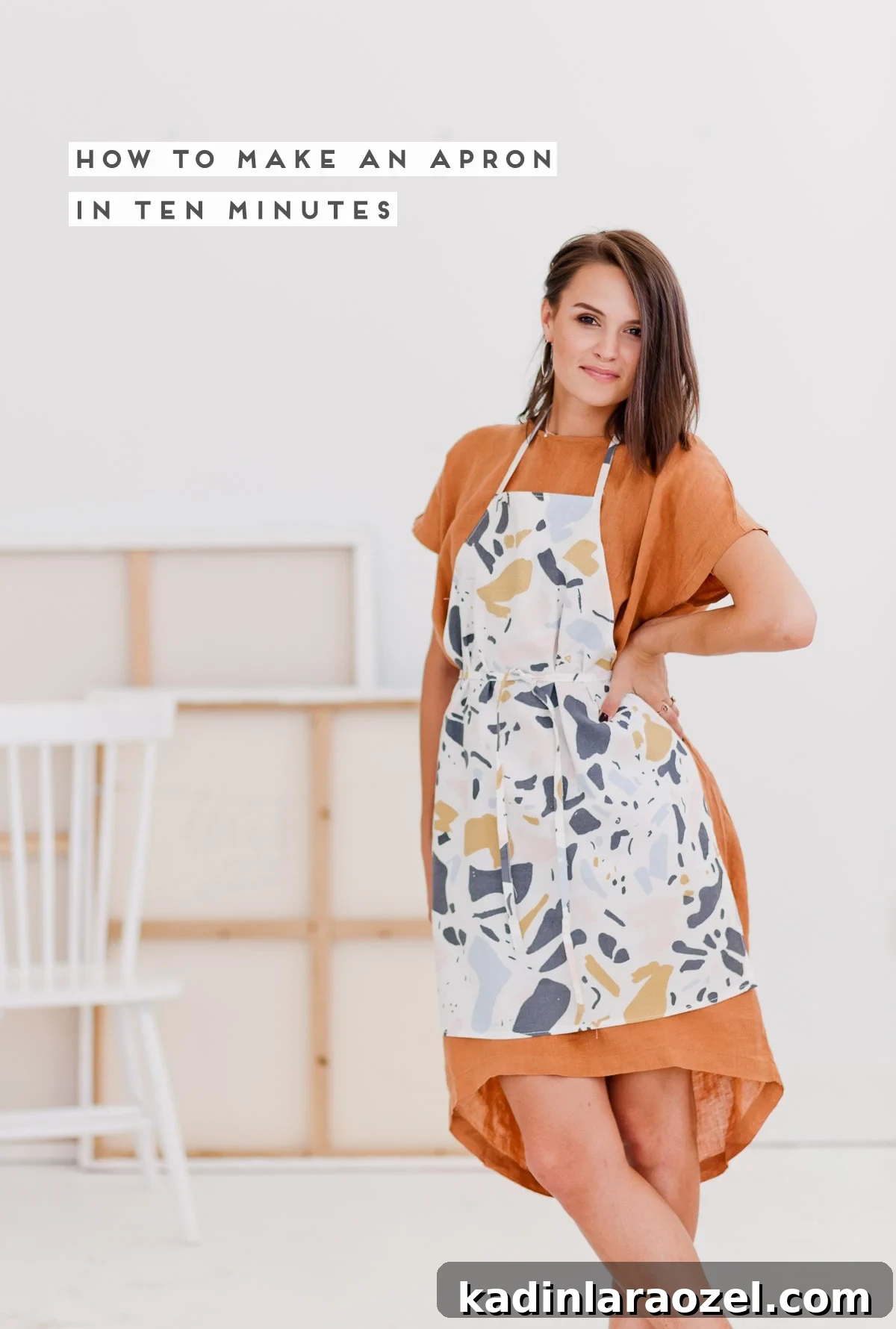 Woman standing in artist loft, wearing a DIY apron.