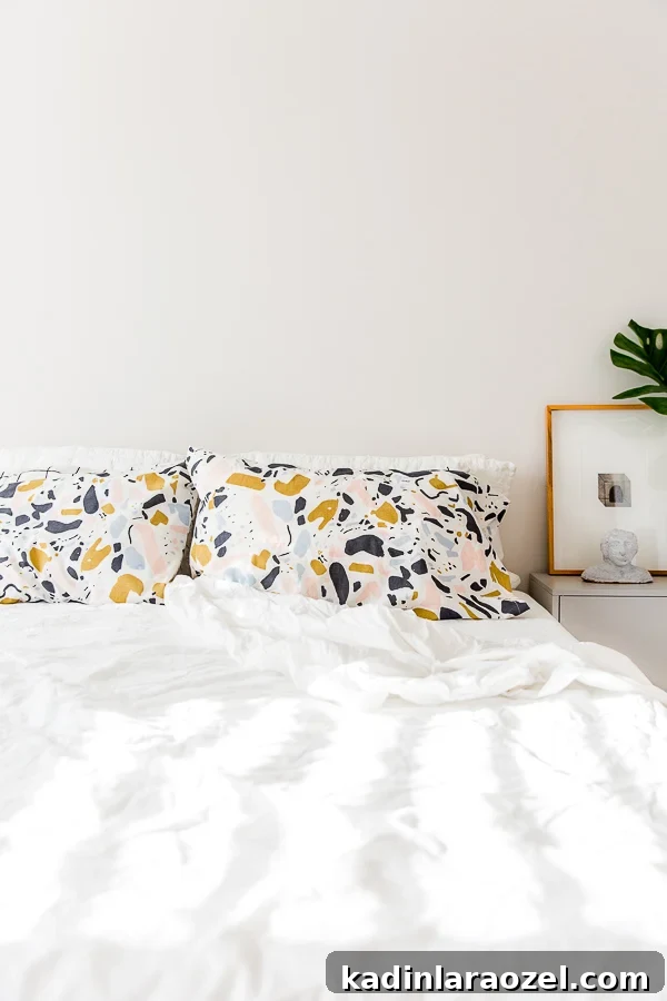 White bedroom with white bedding and a pop of pattern