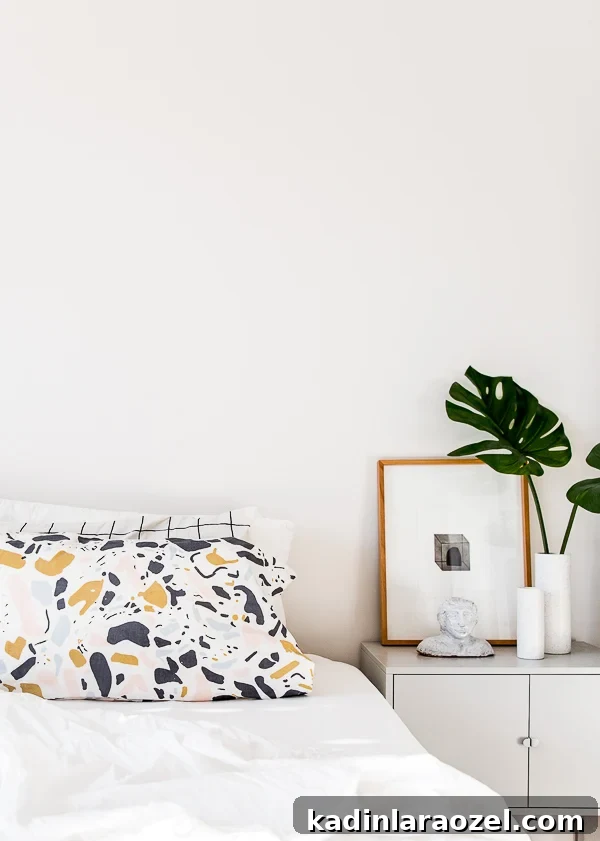 Minimal, white bedroom with modern pattern pillowcases