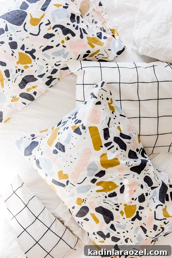 Multiple pillowcases on white bedding with terrazzo print fabric and grid pattern