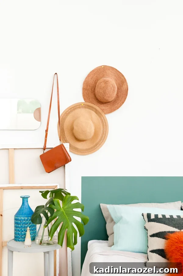 One-Hour DIY Headboard Project: Stylish Design You Can Build Now 16 Painted headboard in green with hats hanging overhead.