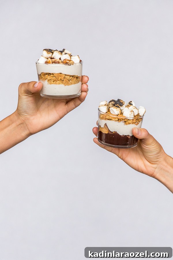 holding up small stores cups with hands on a plain background 