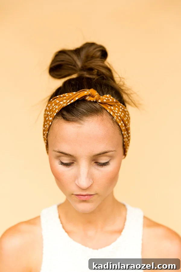 Woman wearing a bandana, styled as a mustard yellow headband.