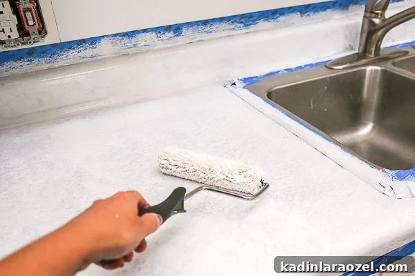 Resurface Laminate Countertops Yourself for Under $50 7 Painting countertop coating onto surface.