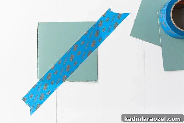 Tape off the triangle shape on each tile to create an eye-catching pattern.