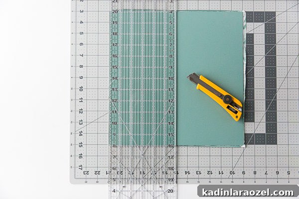 Measure and cut the vinyl tiles into smaller tiles to mimic the look of cement backsplash tiles.