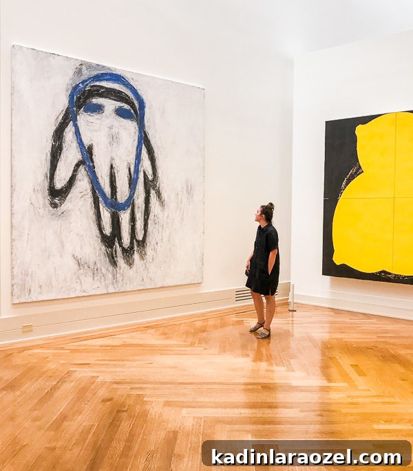 Woman standing in front of giant abstract painting at a art museum in Richmond, Virginia