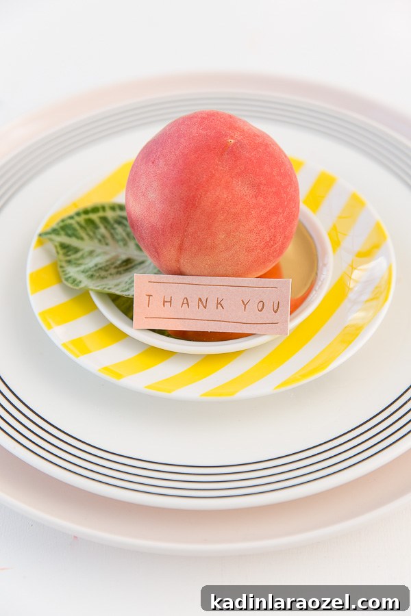 Host an Effortless-Looking Dinner Party (That Really Is) 5 A simple chic place setting with blush and striped plates.