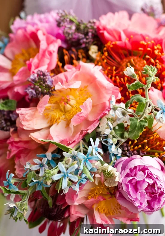 closeup bouquet of pink peonies, garden roses, lilacs, protea, and more