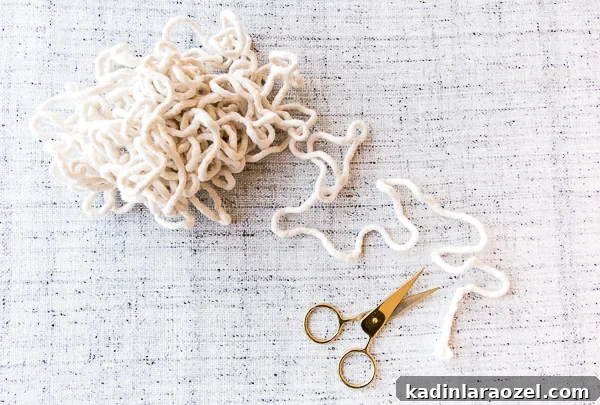 Make a Potholder Using Just One Material 4 bundled up cotton piping with scissors on light grey tablecloth