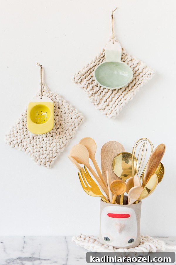 Make a Potholder Using Just One Material 9 white minimal kitchen with marble counters and beige potholders hanging on wall