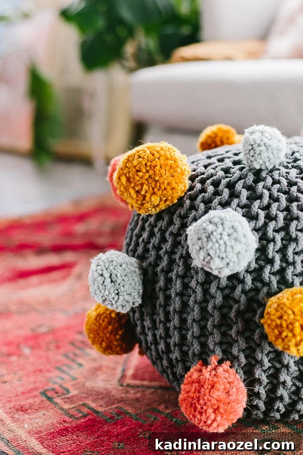 DIY pom pom ottoman. Click through for the tutorial.