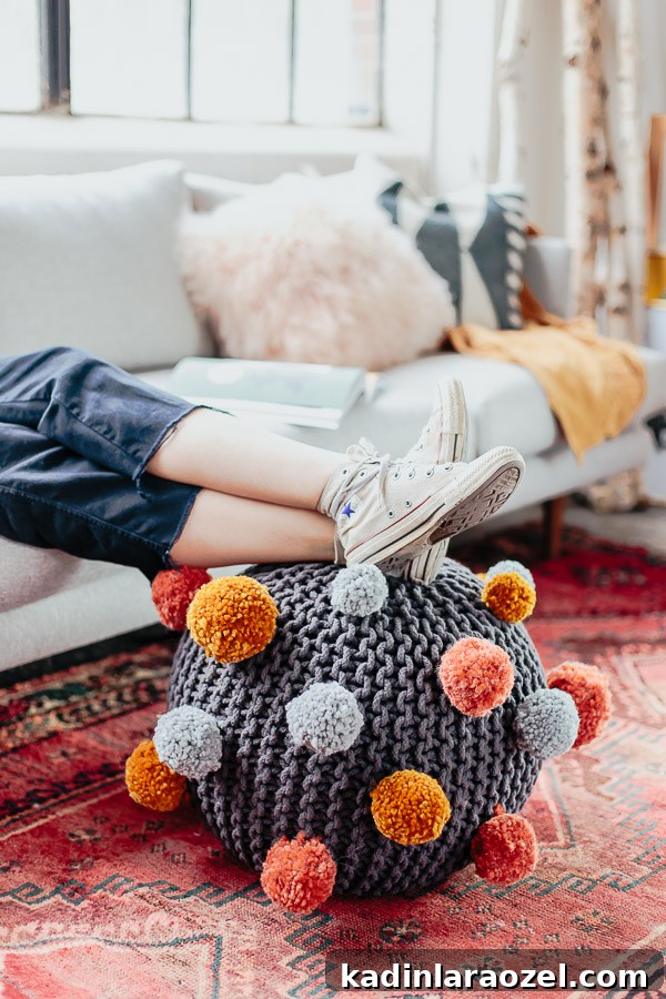 How to make a DIY pom pom ottoman. Click through for the tutorial.