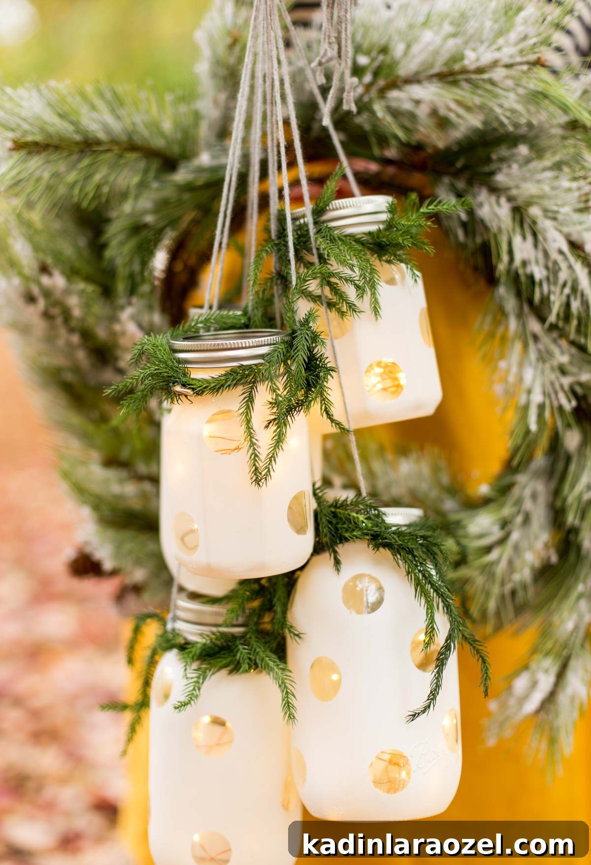 Woman in yellow skirt, holding holiday hanging lanterns, with a wreath