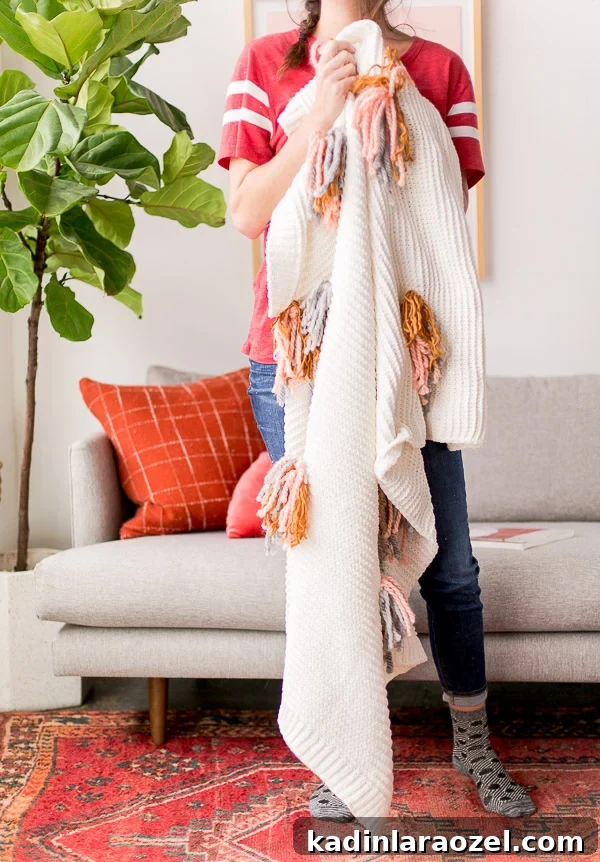 DIY Tassel Blanket Tutorial for a Cozy Winter Home 4 Cozy up with this DIY tassel blanket for winter. It's an easy project, with a little yarn and an existing knit blanket. Click through for the step by step instructions. #diy #blanket #tassel #interiors #homedecor #housewares #cozy #winter