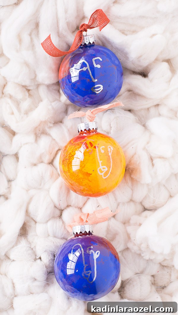 DIY Holiday Ornaments: A Complete Guide to Stylish Decorations 6 Colorful glass ornaments with hand drawn faces on each one.