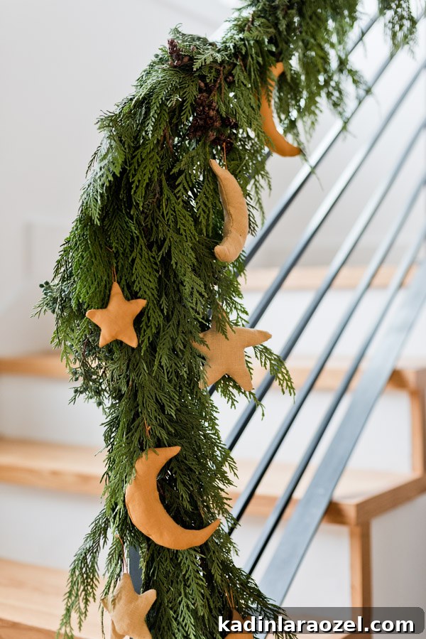 DIY Holiday Ornaments: A Complete Guide to Stylish Decorations 8 Linen fabric, golden star ornaments hanging off of Christmas garland on staircase.