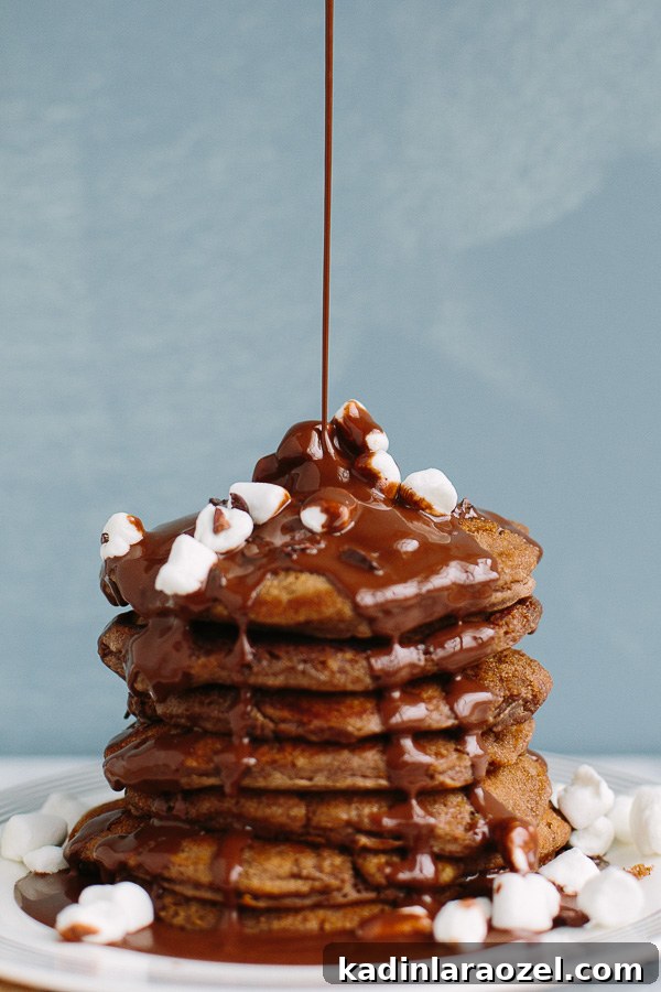 Hot Chocolate Pancakes topped with marshmallows and chocolate syrup