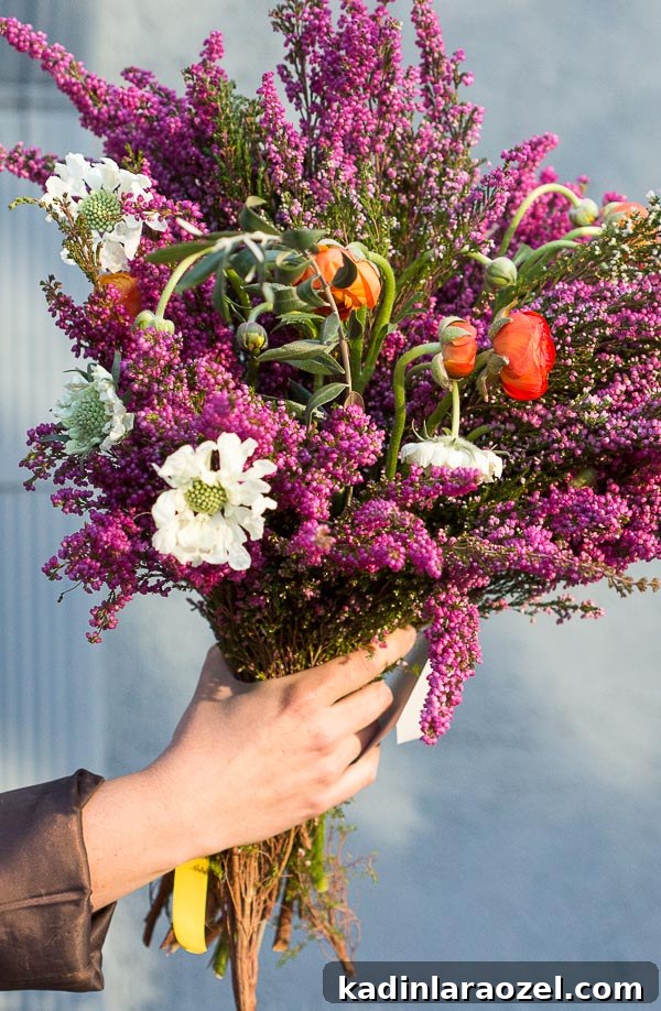 DIY Doorstep Flower Bomb: Surprise Your Neighbors with Blooming Planters 5 A giant bouquet of heather, ranunculus, scabiosa, etc. #flowerpower #flowers #bouquet #floral #colorful #blue #purple