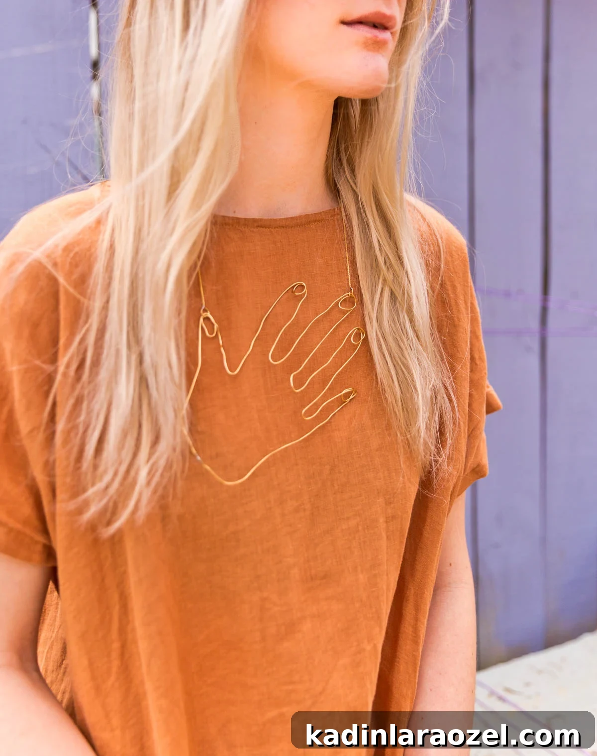 Wire Hand Necklace Tutorial: Beginner Soldering Project Guide 10 Woman wearing brown linen dress and statement necklace with wire hand design