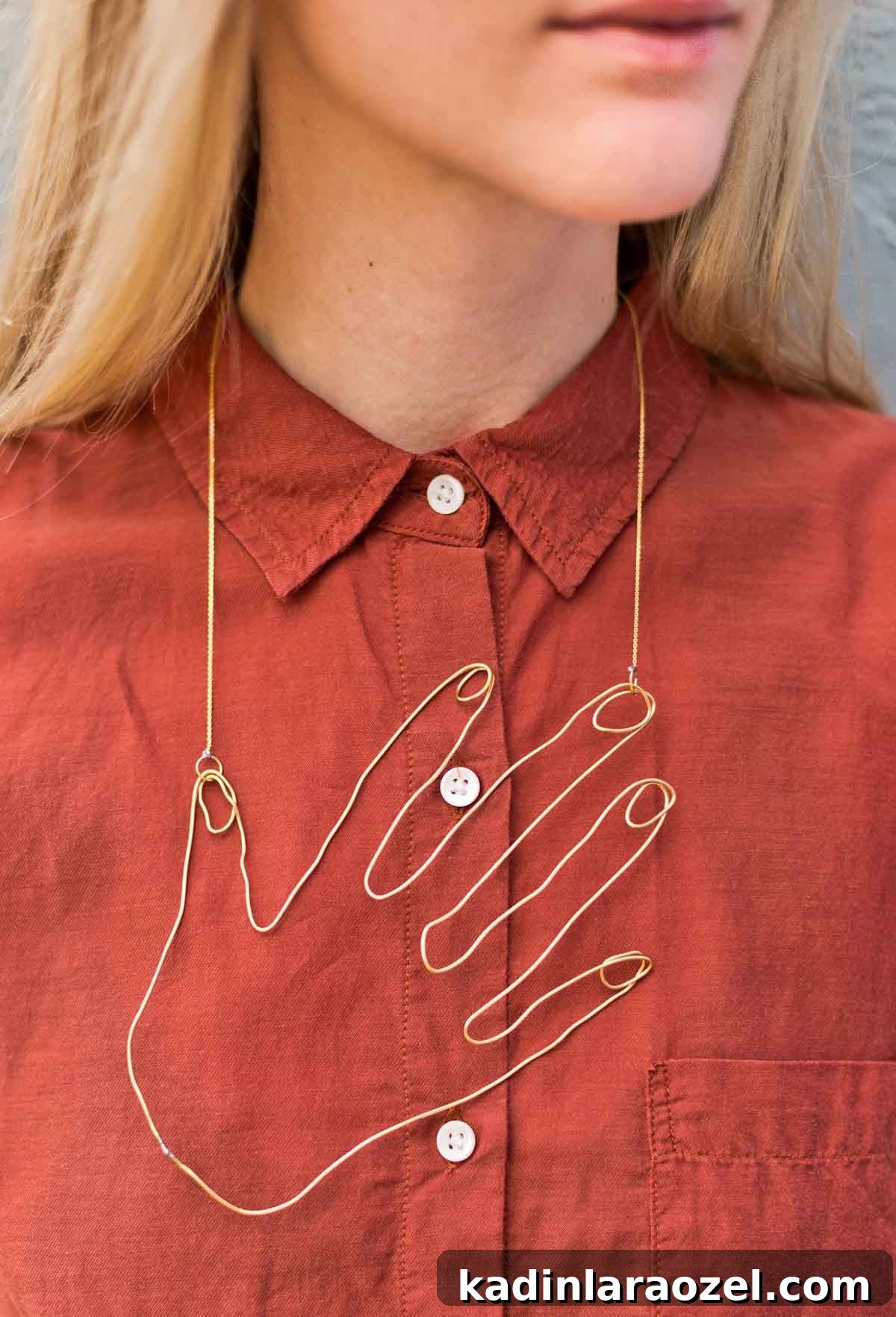 Wire Hand Necklace Tutorial: Beginner Soldering Project Guide 11 Woman wearing rust colored button down shirt and large hand-shaped necklace