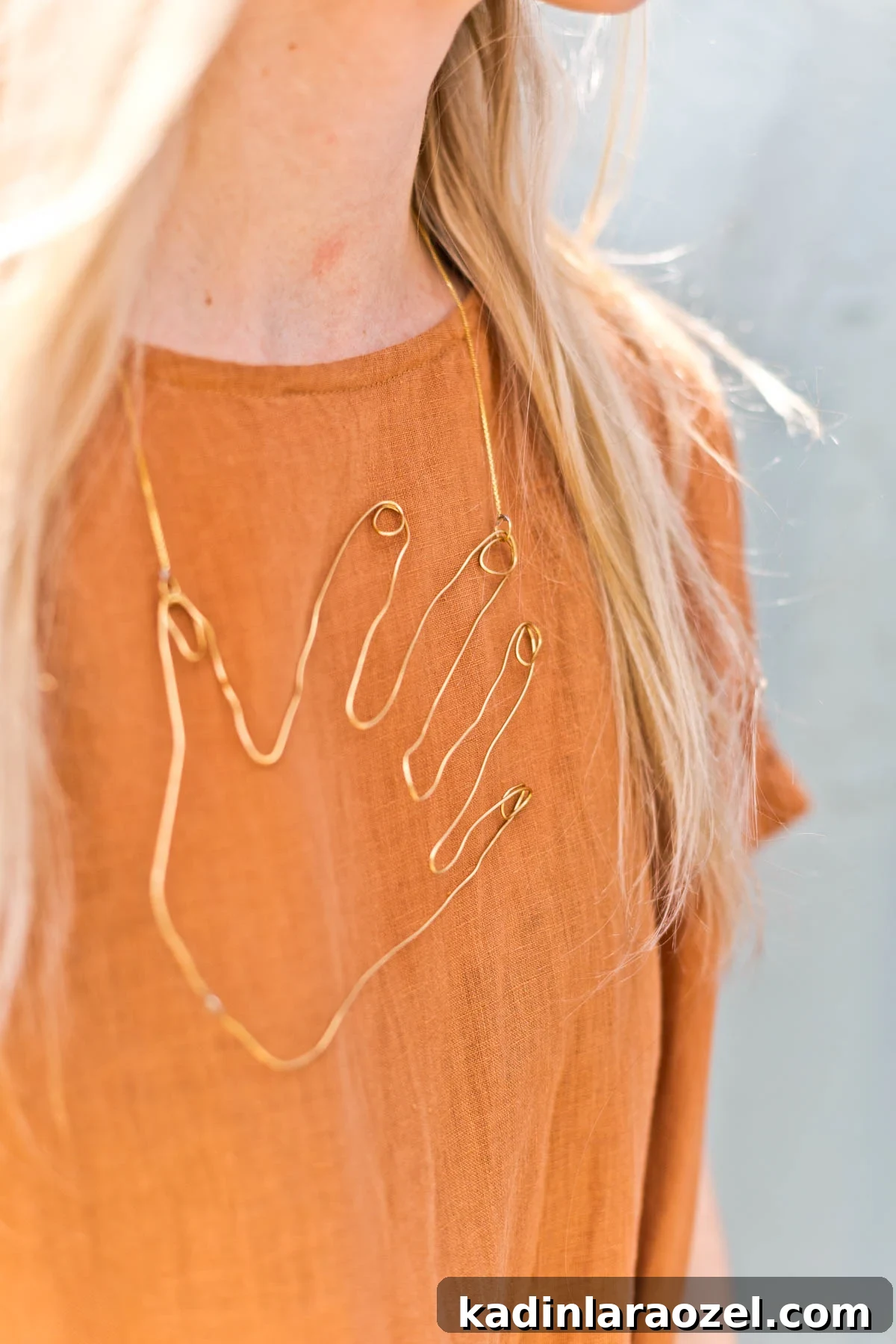 Wire Hand Necklace Tutorial: Beginner Soldering Project Guide 12 Woman wearing linen dress and statement jewelry