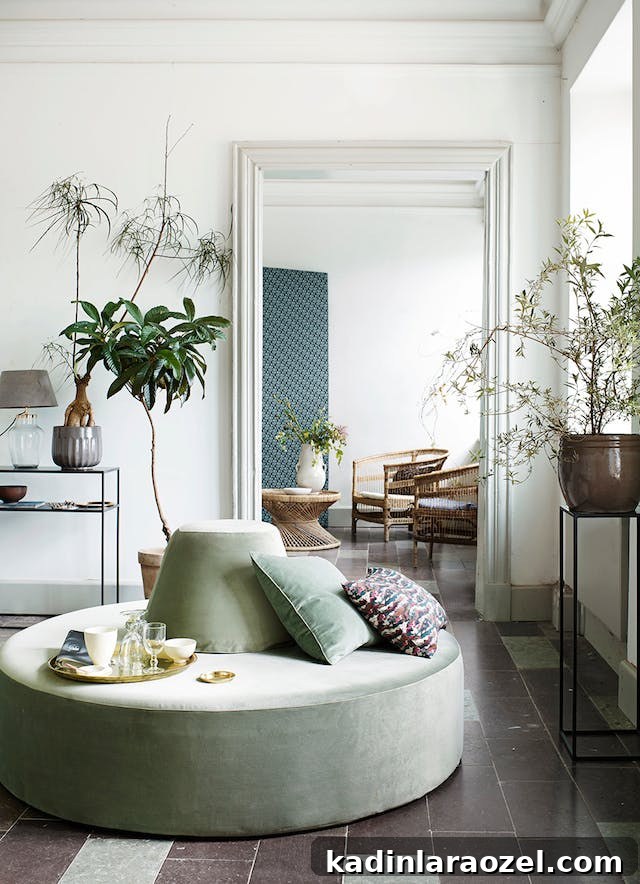 Why Sage Green Is Trending: 9 Reasons to Love the Shade 3 Photo of sage green circular seating in middle of organic modern living room.