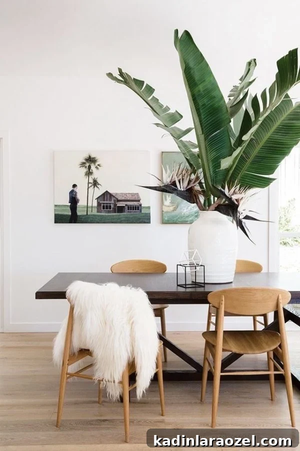 dining table in modern home with giant palm fronds in a vase on the table