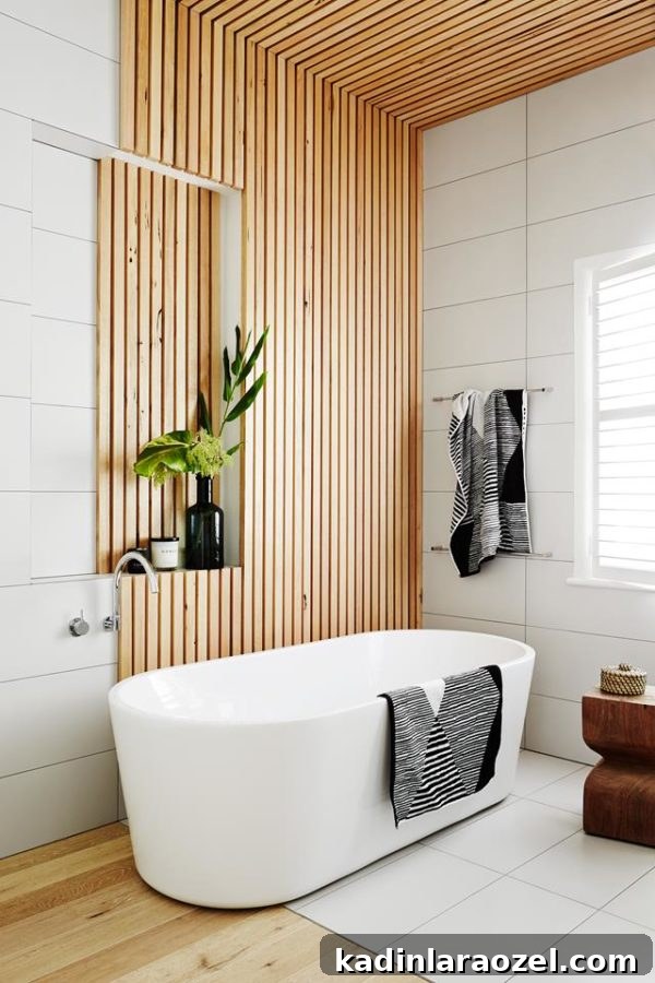 Minimal bathroom with freestanding tub and wood slat wall