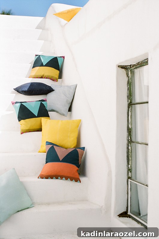 white stairs in Greece with colorful geometric pillows