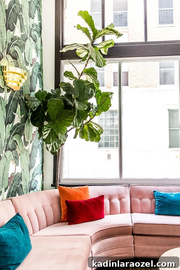 Tropical wallpaper in hotel lobby with pink sectional sofa