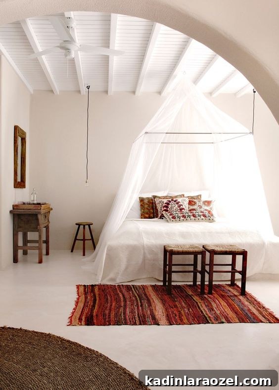 White room with canopy bed and striped rug