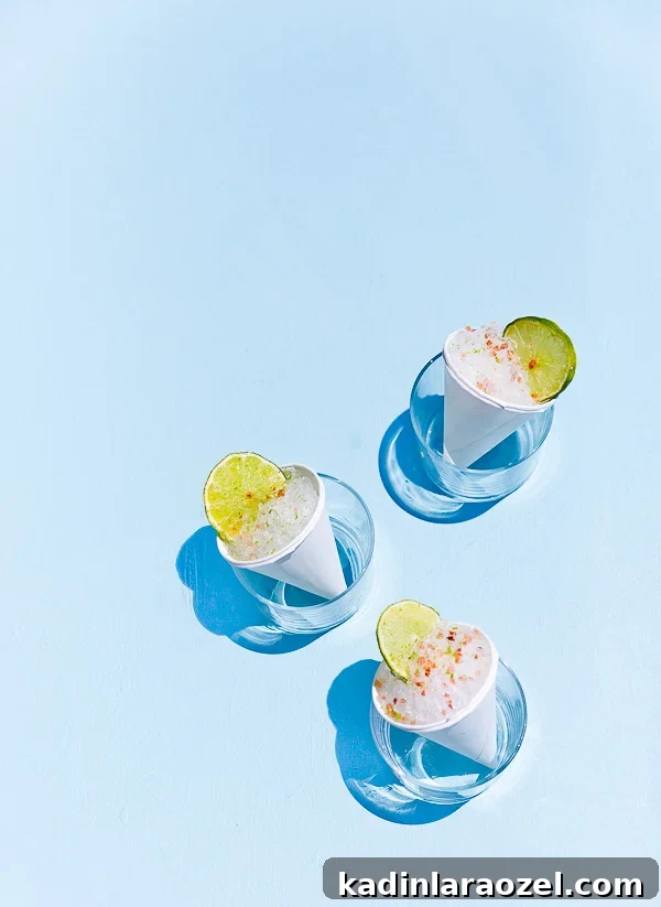 Cone Head Margarita Snow Cones: Frozen Cocktail Shaved Ice 2 Margarita snow cones sitting in short clear glasses, before the melt in the sun